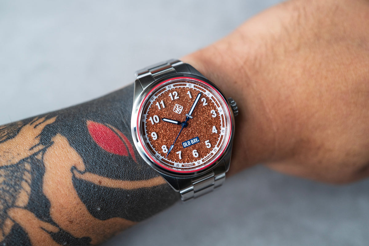 The Old Bay watch’s seasoning-inspired dial worn on the wrist.